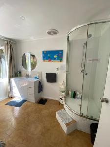 a bathroom with a shower and a sink at ADA Homestay in Doncaster +80 photos