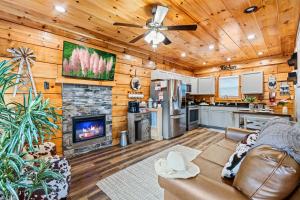 a living room with a couch and a fireplace at Rustic Mountain Retreat by Ghosal Luxury Lodging in Pigeon Forge
