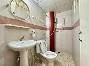 a bathroom with a toilet and a sink and a mirror at Pakdee House in Udon Thani +41 photos