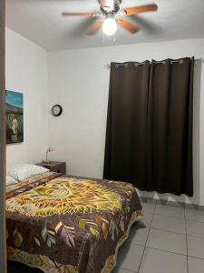 a bedroom with a bed and a ceiling fan at Hospedaje Samao in Santa María del Oro +14 photos