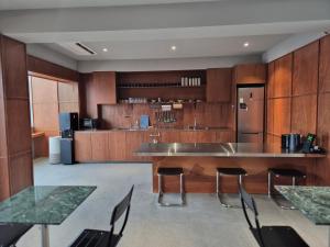 a large kitchen with wooden cabinets and a table and chairs at Cabinet 캐비넷 양양 in Yangyang