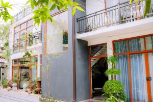 a facade of a building with windows and plants at Gampaha Heritage in Gampaha +57 photos