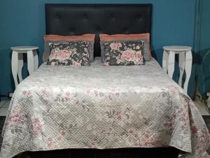 a bed with pink and white sheets and pillows at la reyna in Monte Grande