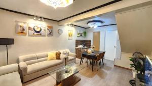 a living room with a couch and a table at Raed Homestay by ASH in Biñan