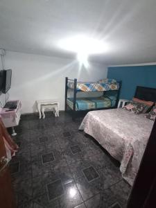 a bedroom with two bunk beds and a television at la reyna in Monte Grande
