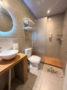 a bathroom with a toilet and a sink and a shower at Martita House in Clorinda +27 photos