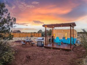 a rv with a wooden deck and a picnic table at Grand Canyon Stargazing Camper in Williams