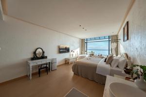 a bedroom with a bed and a table and a mirror at Blue Sea Hotel in Dali