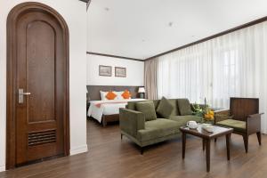 a living room with a couch and a bed at Paul Chabot Hotel in Hai Phong +112 photos