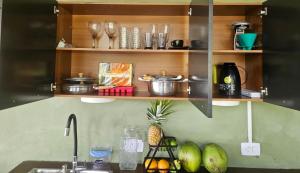 a kitchen with wooden shelves and a kitchen sink at Porto Taipu in Marau