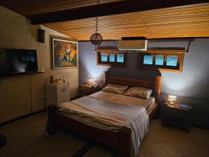 a bedroom with a bed and a television in it at Porto Taipu in Marau +68 photos