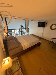 a bedroom with a bed and a large window at Ti Coin Soleil in Saint-Paul