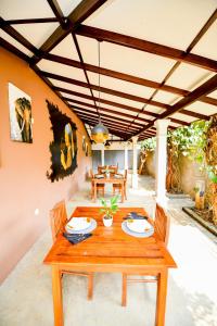 a wooden table and chairs on a patio at Summerland Residence in Udawalawe