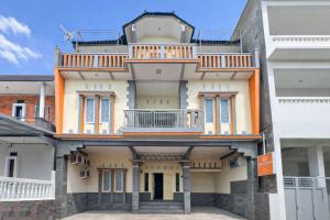 a large building with a balcony on top of it at RedDoorz Syariah at Cimahi in Cimindi