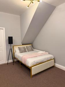 a bedroom with a bed in a attic at Studio Aurelia - Oldham city centre in Oldham