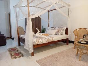 a bedroom with a bed with a canopy at The wave Dickwella in Dickwella