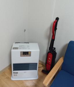 a vacuum cleaner sitting next to a microwave at メープル桑園駅202 in Sapporo