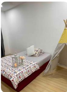 a bed in a room with a tent at daisy apartment taiping in Taiping