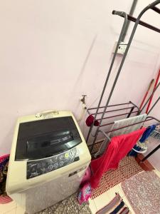 an old computer sitting on the floor in a room at Homestay Arich in Permatang Pauh