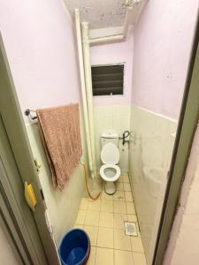 a small bathroom with a toilet and a window at Homestay Arich in Permatang Pauh