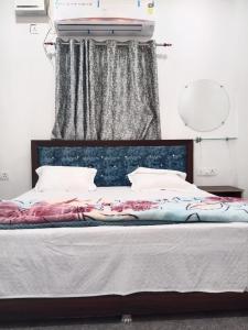 a bedroom with a bed with a canopy and a window at Ram Priya hotel in Basāri