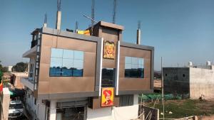 a brown building with windows on the side of it at Ram Priya hotel in Basāri