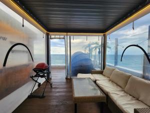 a living room with a couch and a view of the ocean at Mr. Slow in Sokcho