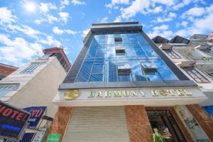 a tall building with the words harlem many hotel at Harmony Hotel in Hanoi