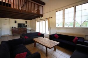 a living room with couches and a coffee table at La vauloube in Châteauponsac