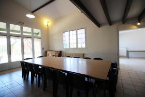 a conference room with a large wooden table and chairs at La vauloube in Châteauponsac