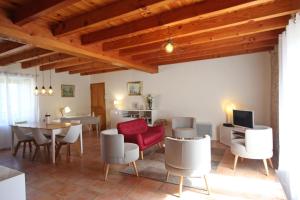 a living room with a red couch and a table at Le borland in Nantiat +12 photos
