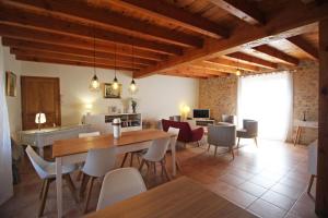 a living room with a dining table and chairs at Le borland in Nantiat