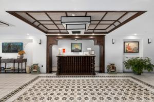 a lobby with a reception desk and a ceiling at Paul Chabot Hotel in Hai Phong