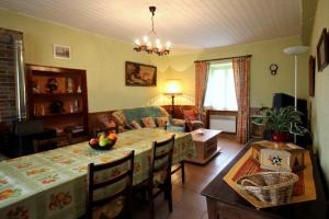 a living room with a table and a dining room at Négrignas in Augne