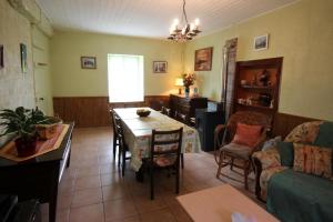 a kitchen and living room with a table and chairs at Négrignas in Augne