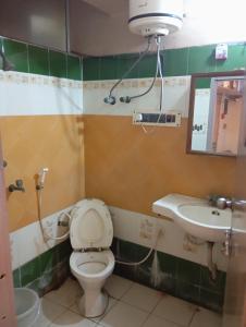 a bathroom with a toilet and a sink at Stay on Ganges near Dakshineswar in Howrah