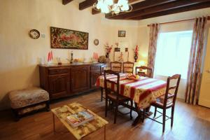 a dining room with a table and some chairs at Négrignas in Augne