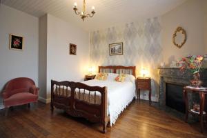 a bedroom with a bed and a fireplace at Négrignas in Augne