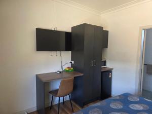 a small kitchen with a desk and a chair at Heritage City Motor Inn in Broken Hill