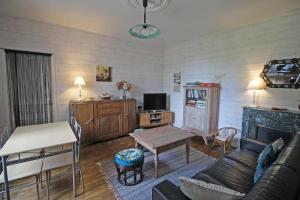 a living room with a couch and a table at Serre in Augne