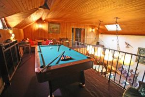 a room with a pool table in a house at Villa du lac in Bujaleuf