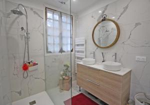 a bathroom with a shower and a sink and a mirror at Villa du lac in Bujaleuf +17 photos