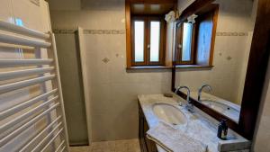 a bathroom with a sink and a tub at Les landes in Champnétery +16 photos