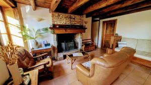 a living room with a couch and a fireplace at Les landes in Champnétery