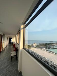 a room with a large window with a view of the ocean at Tuyết Nhi in Vung Tau