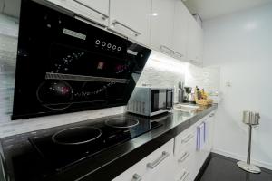 a kitchen with a black stove top oven at Luks Lofts Hotel & Residences in Batangas City +136 photos