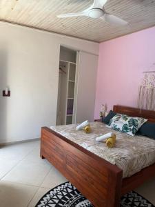 a bedroom with a bed with two stuffed animals on it at Ti Coin Les Coraux in La Saline les Bains +15 photos