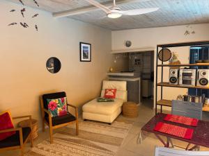a living room with a couch and a chair at Ti Coin Les Coraux in La Saline les Bains