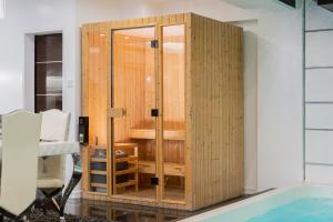 a wooden wardrobe next to a tub in a room at Luks Lofts Hotel & Residences in Batangas City