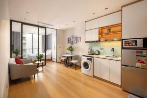 a kitchen and living room with a sink and a dishwasher at Anora Home by BRIO in Danang
